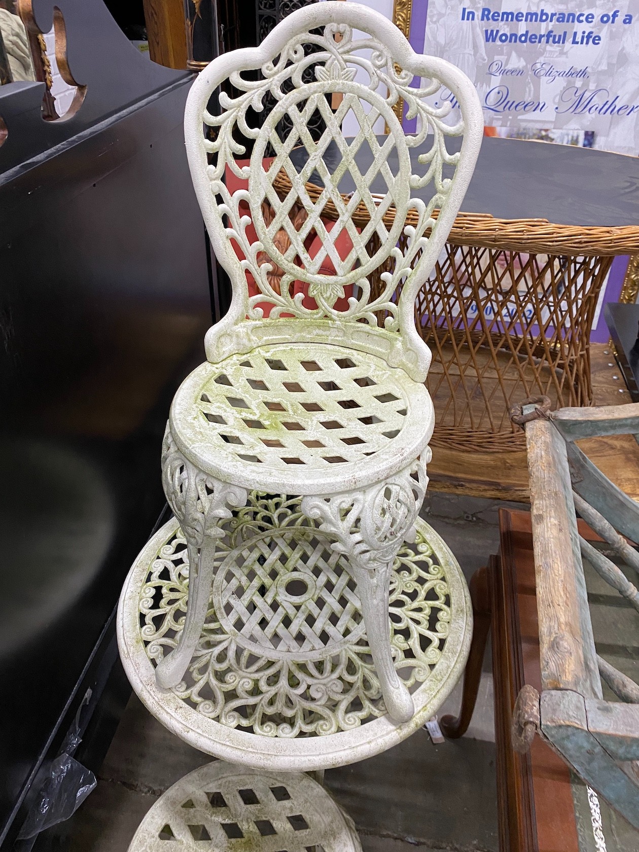 A Victorian style painted aluminum circular garden table, diameter 64cm, height 66cm and two matching armchairs